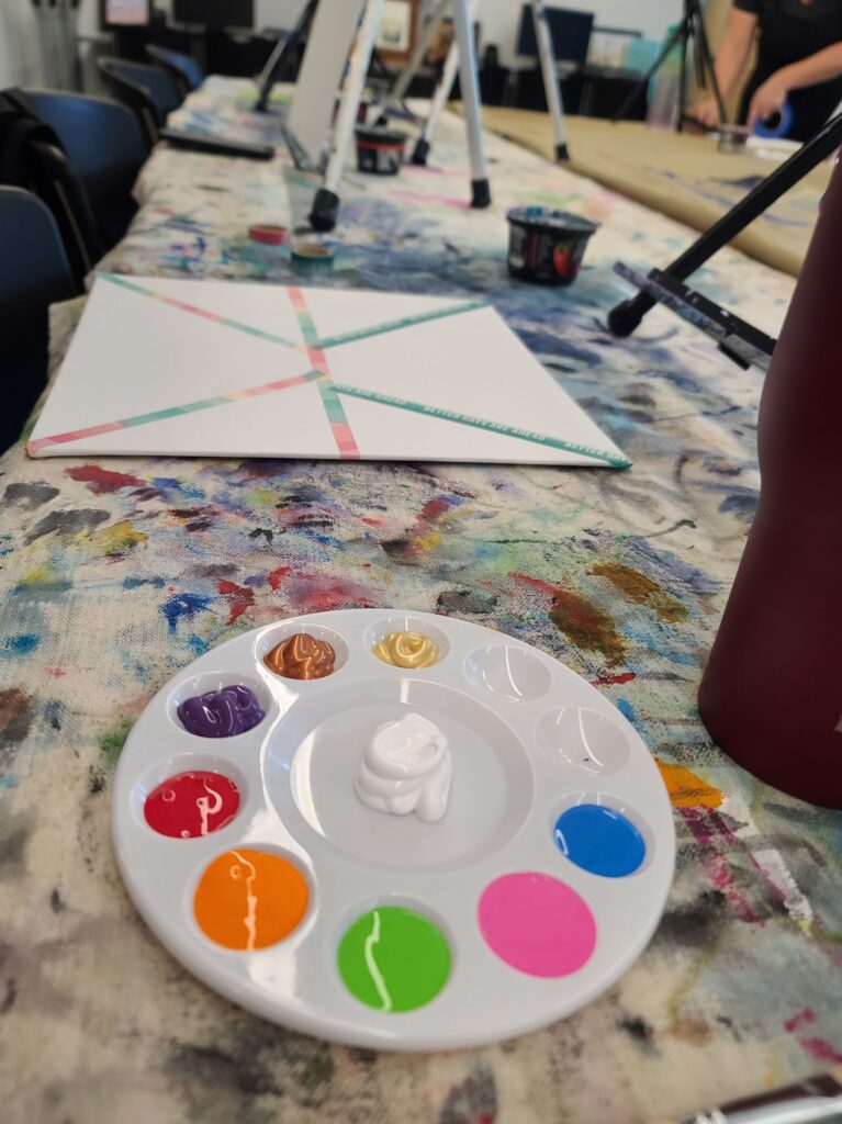 Palette prepared with paint in a variety of colors