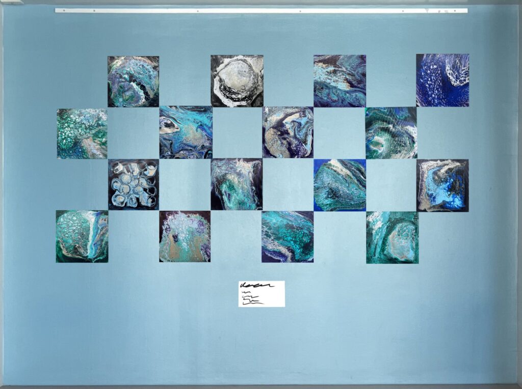 Blue wall with flow art arranged in grid pattern.